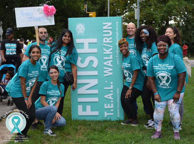 teal walk ovarian cancer run 5k finish line group smile happy awareness