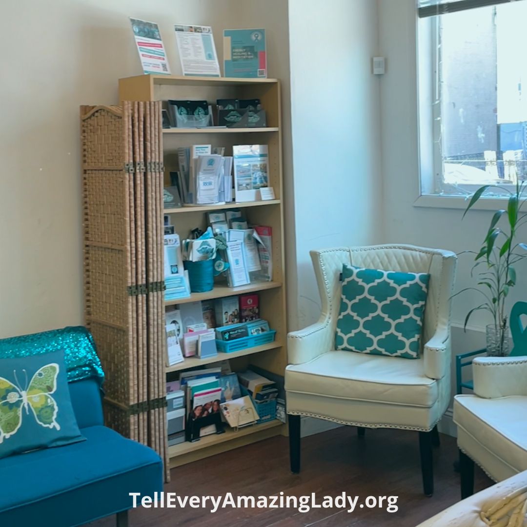 teal community center with chairs and a book case